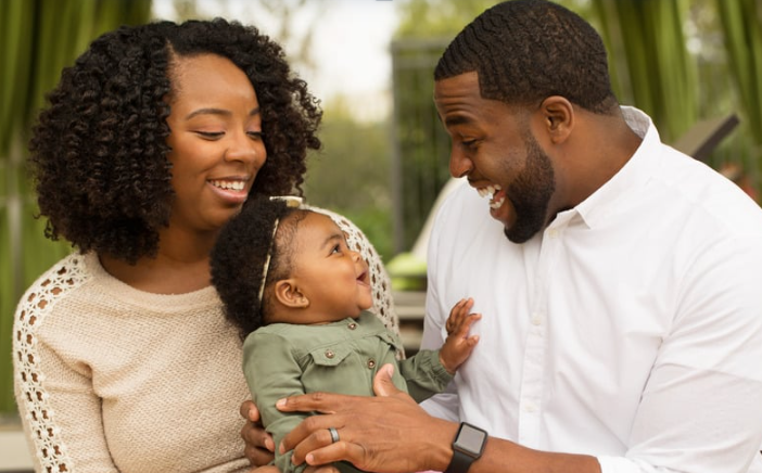 Family holding a child